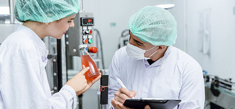 Two-environmental-health-officers-discussing-over-quality-control